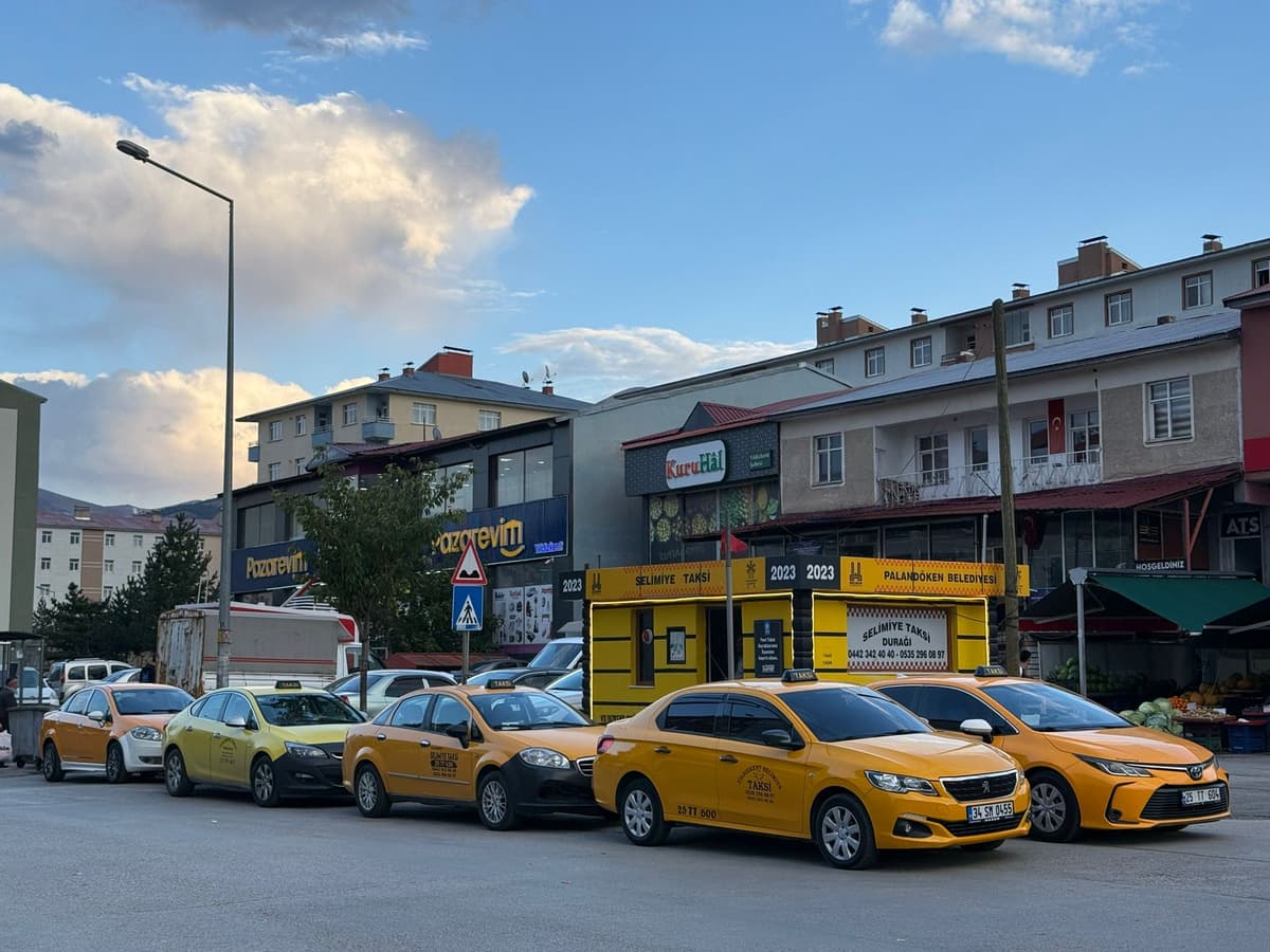 Side view of a yellow taxi in motion.