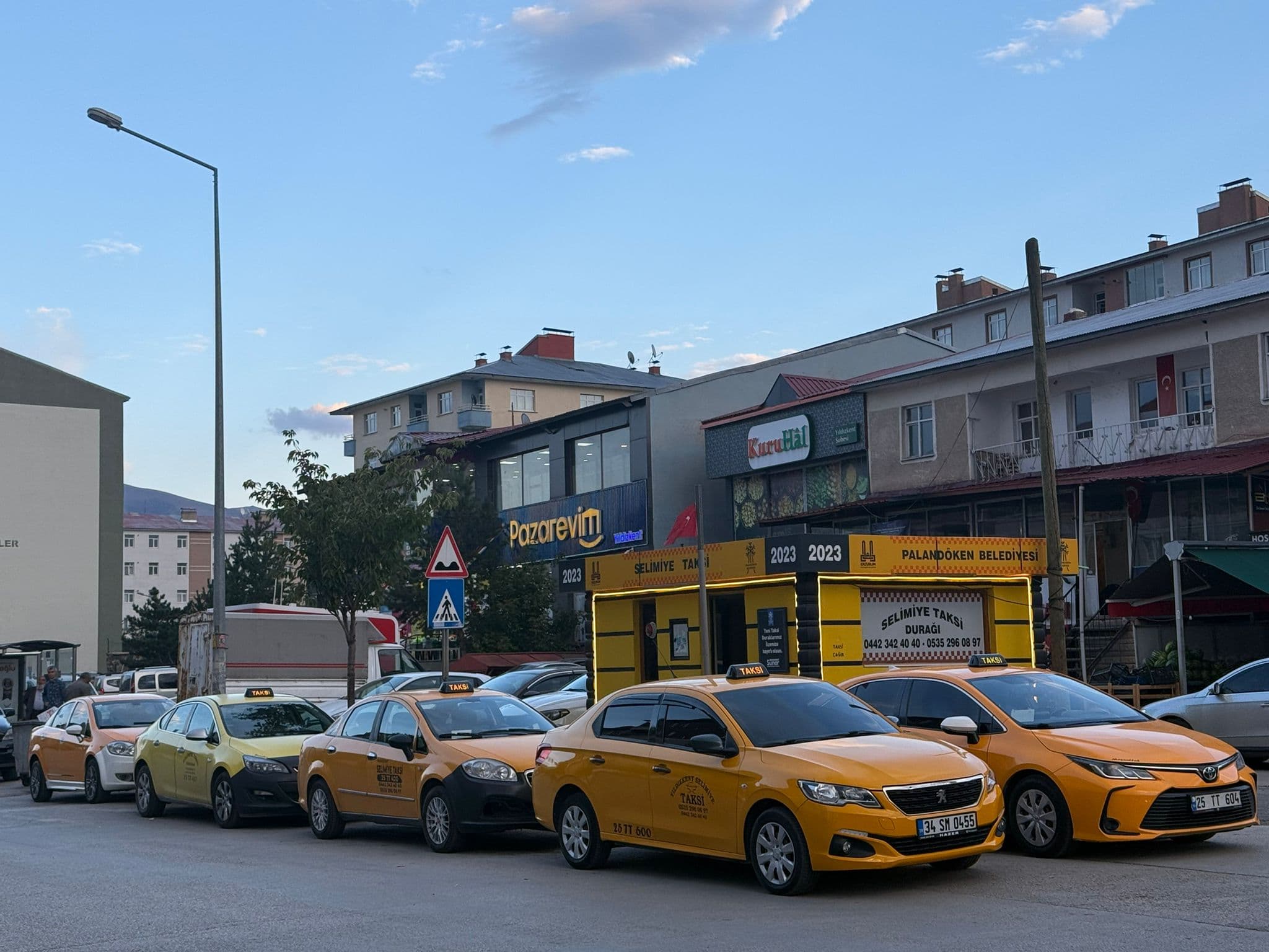 A professional and friendly taxi driver smiling.